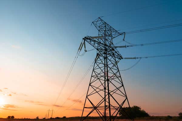 Silhouette of electricity powerlines at dawn